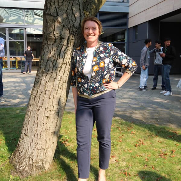 Frau Steht Lachend Neben Baum Bei Holz Bewegt Veranstaltung Im Freien.
